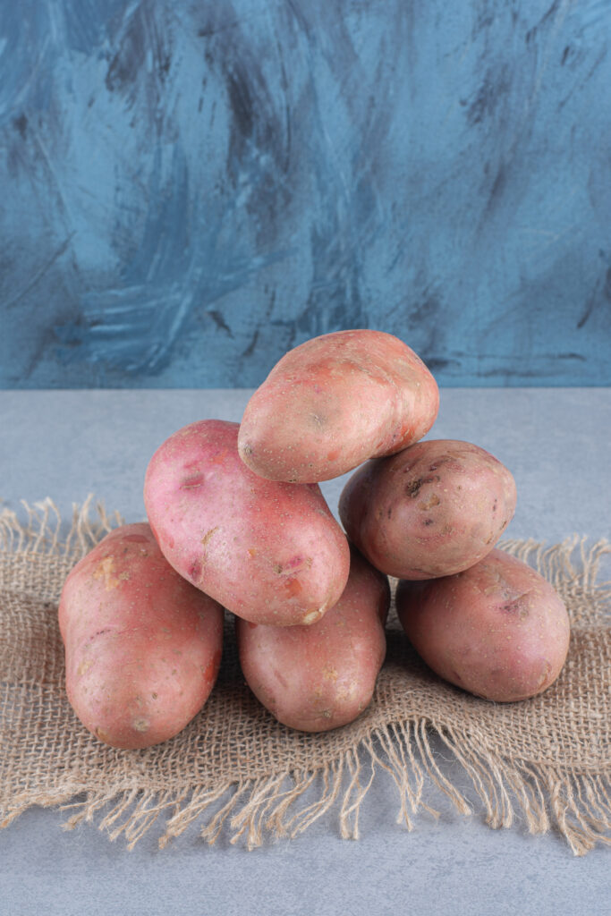 stack of organic red potato on sack